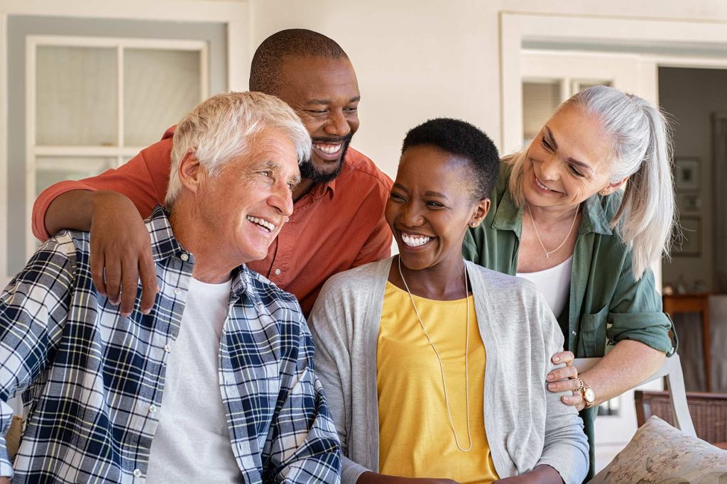 Group of people laughing on the porch